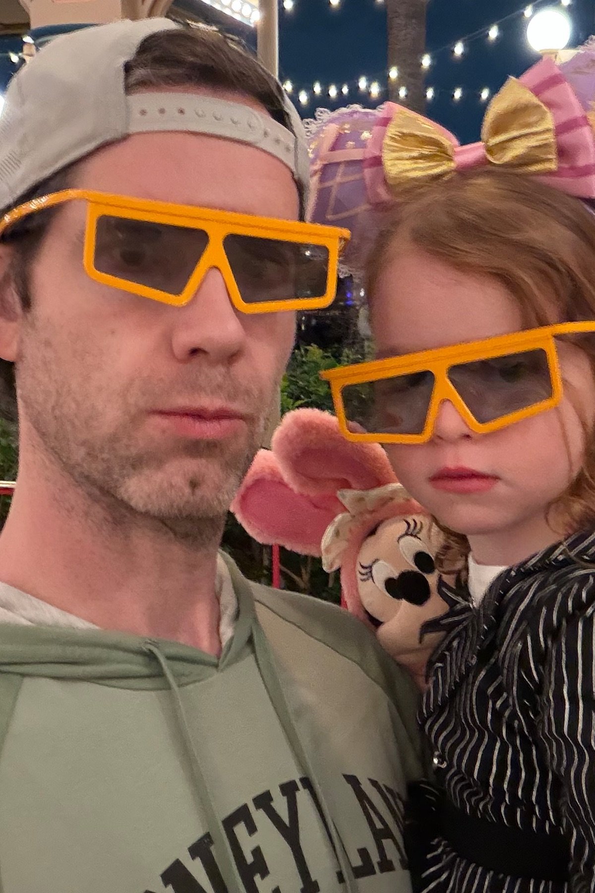 James and his daughter wearing playful 3D glasses at Disneyland