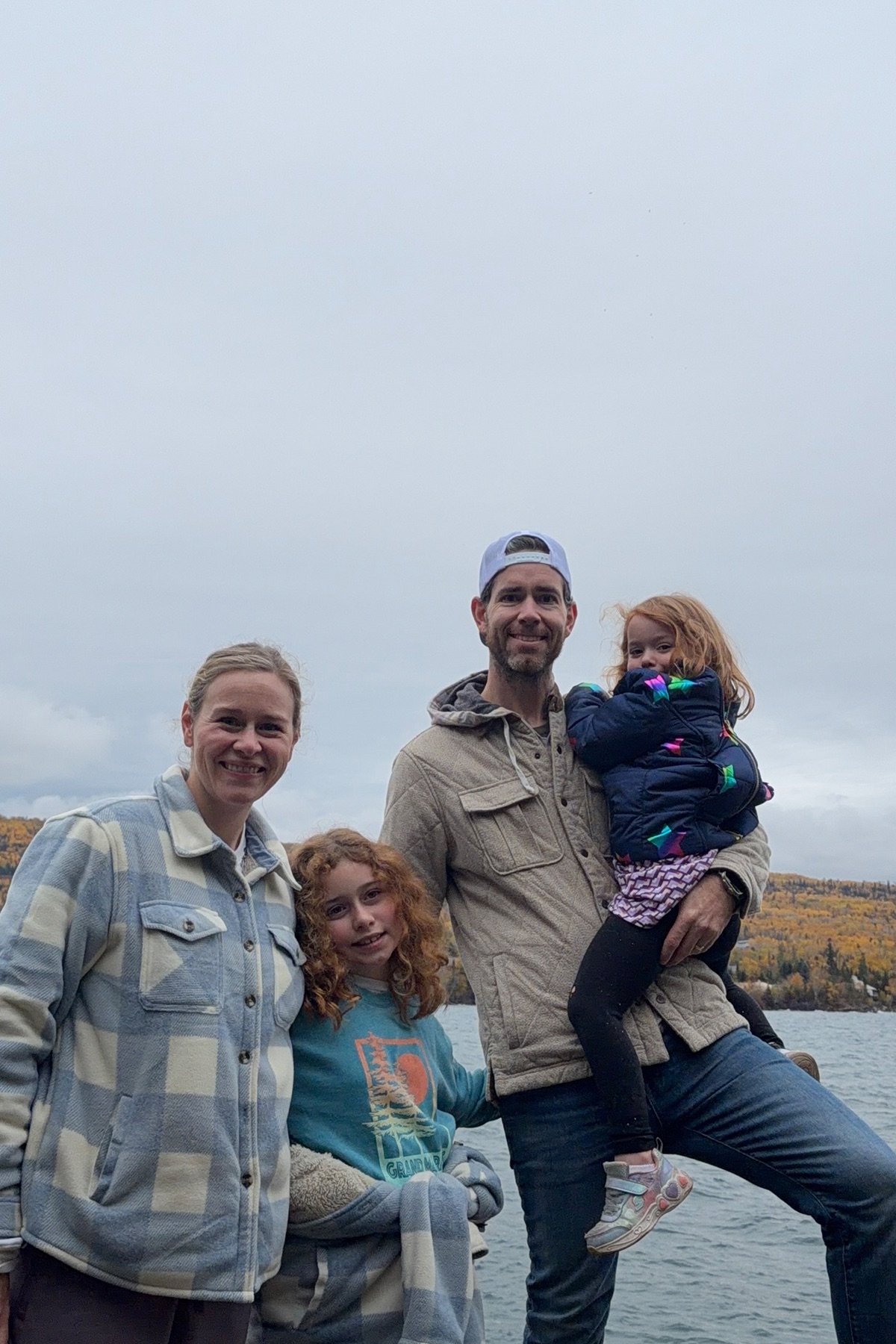 James, Emily, Matilda, and Ramona together beside a lake in autumn
